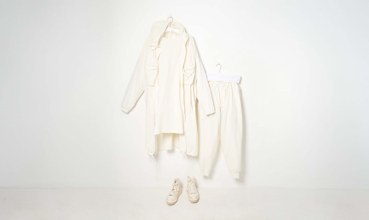 white cotton trousers, sweater and raincoat training outfit
