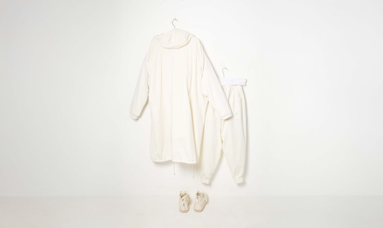 white cotton trousers, sweater and raincoat training outfit