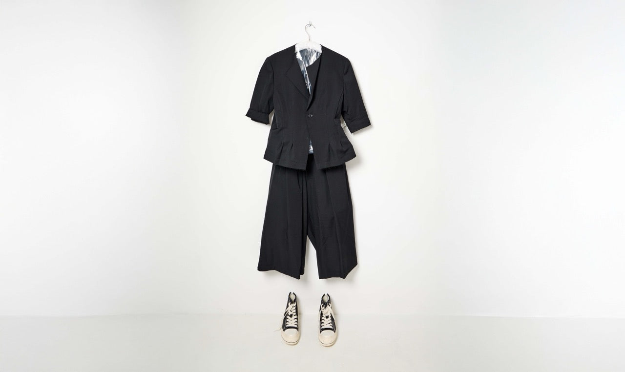 black collarless jacket and ribbed pants look