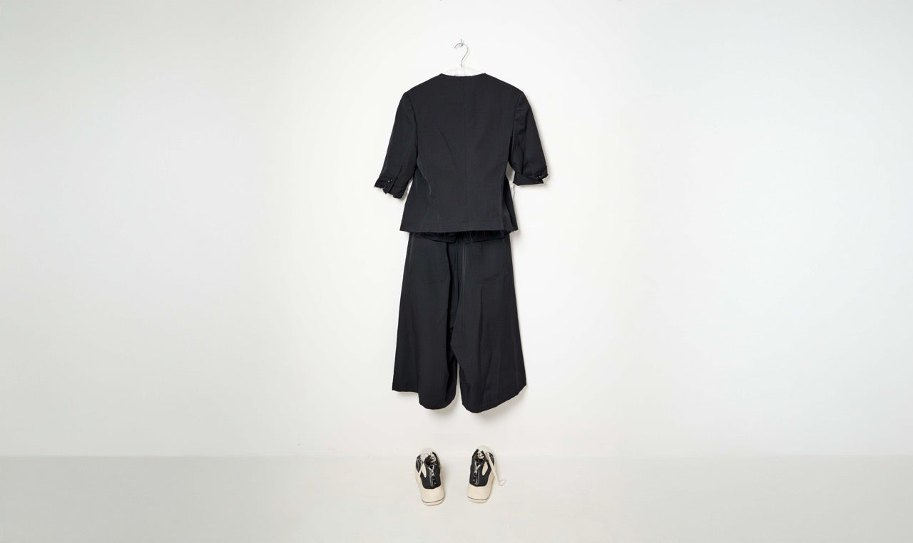 black collarless jacket and ribbed pants look