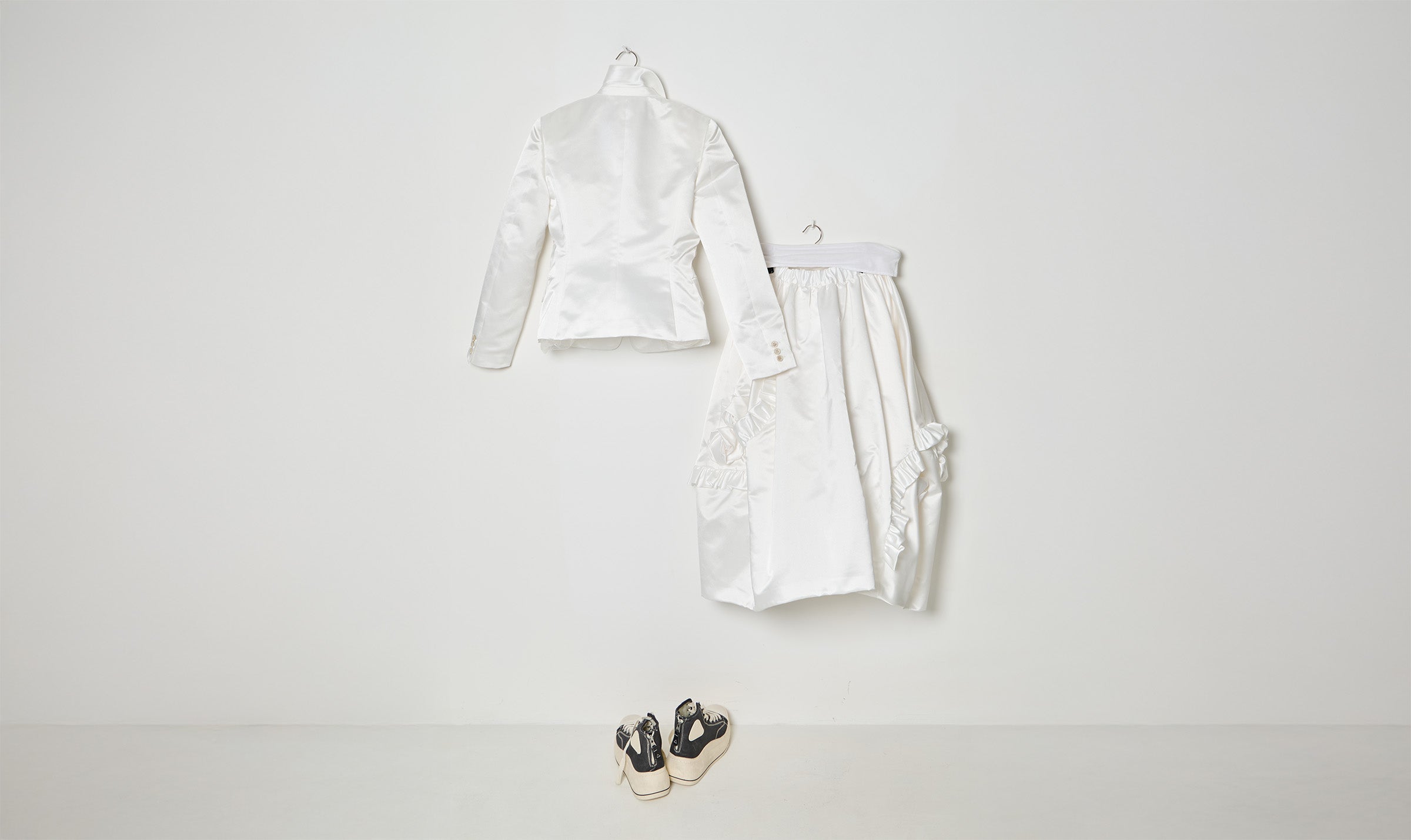 white draped jacket and skirt outfit