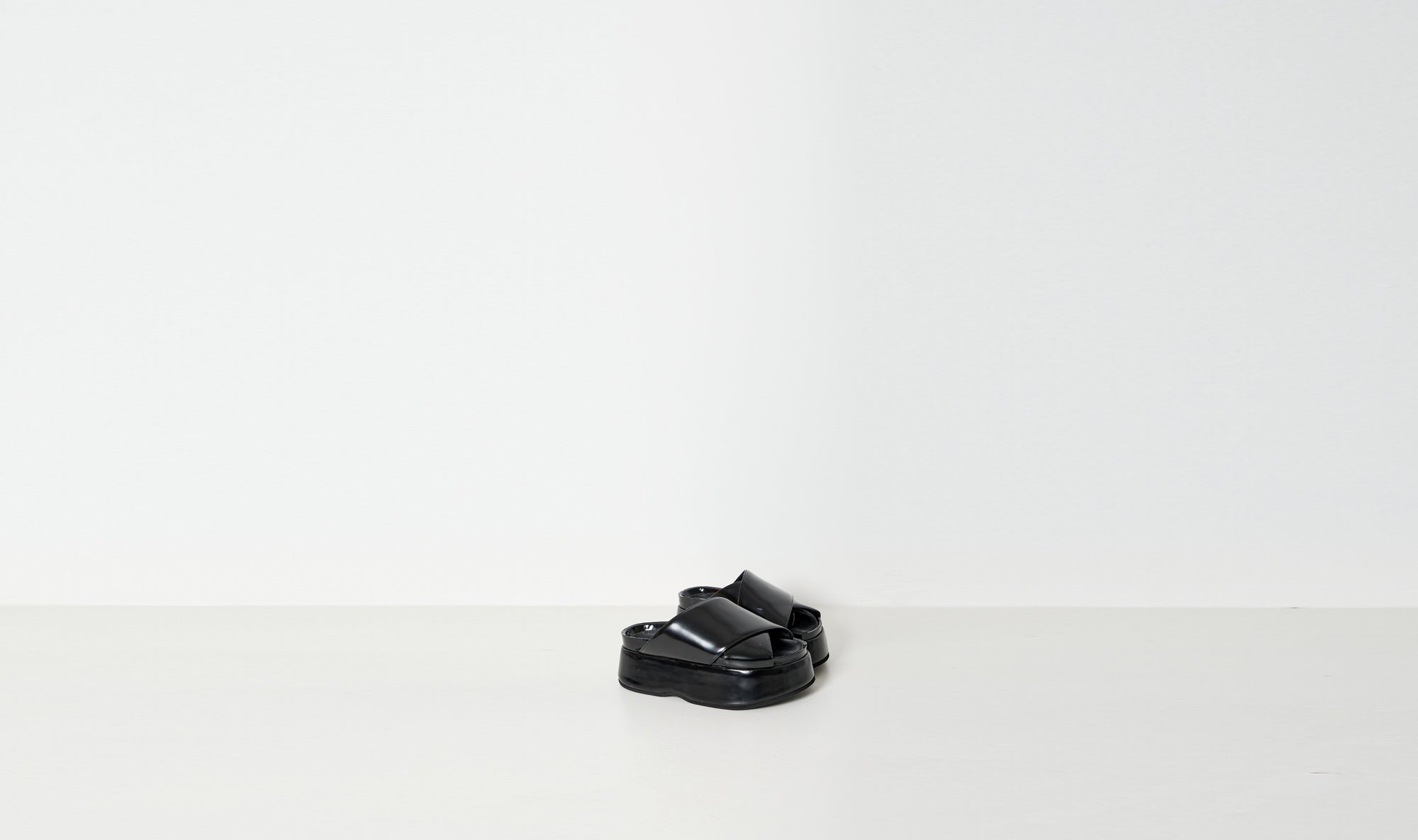 black shiny leather slippers