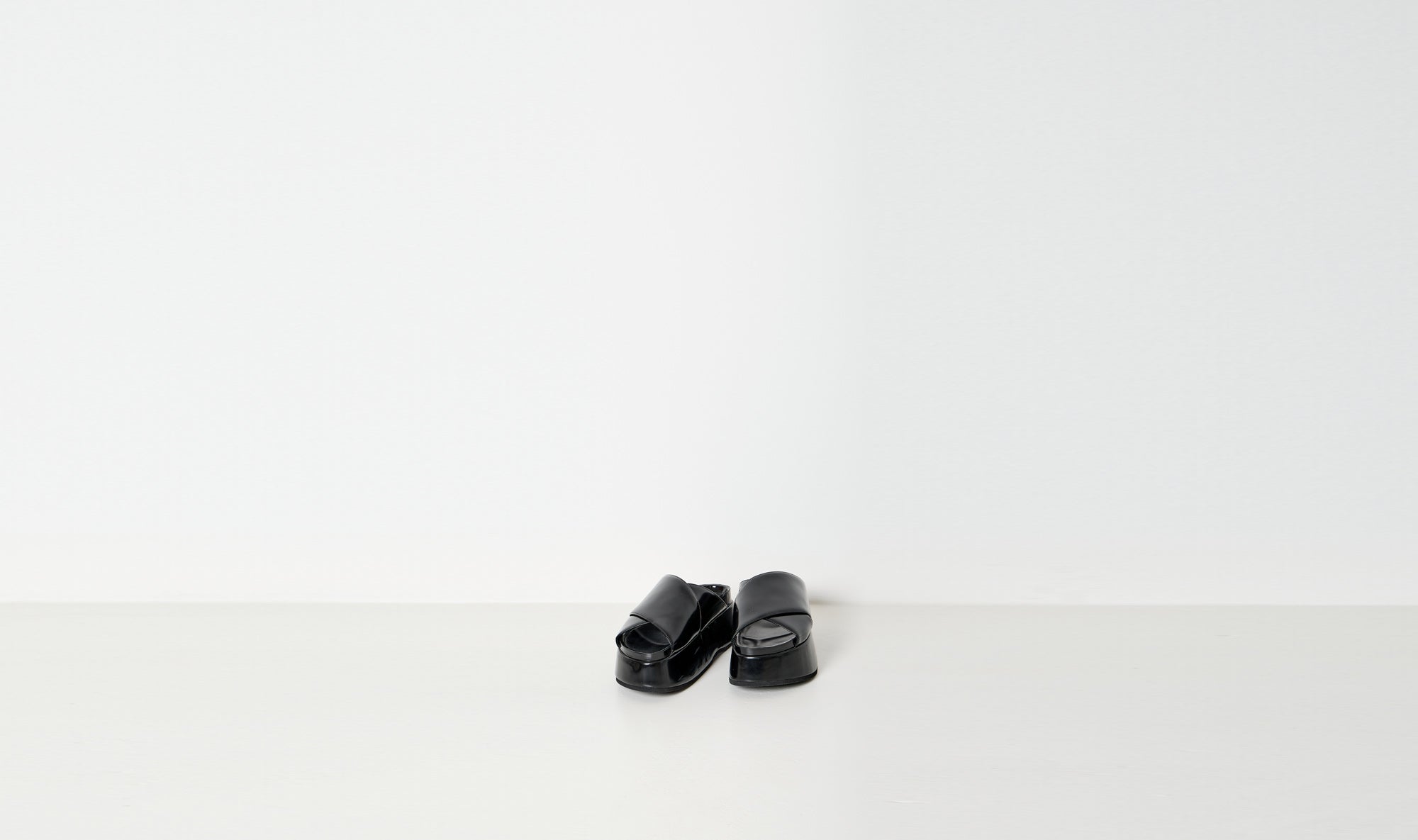 black shiny leather slippers